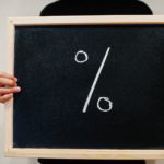 Percent % written on blackboard. Black friday concept. Boy hold board.